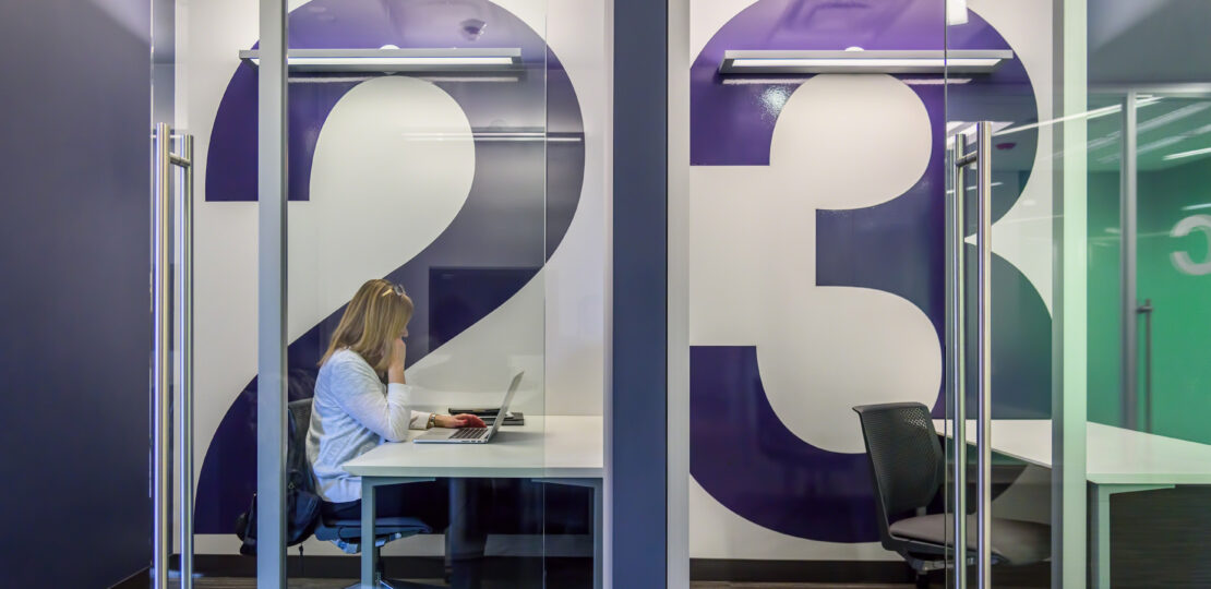 woman sitting in modern office using laptop